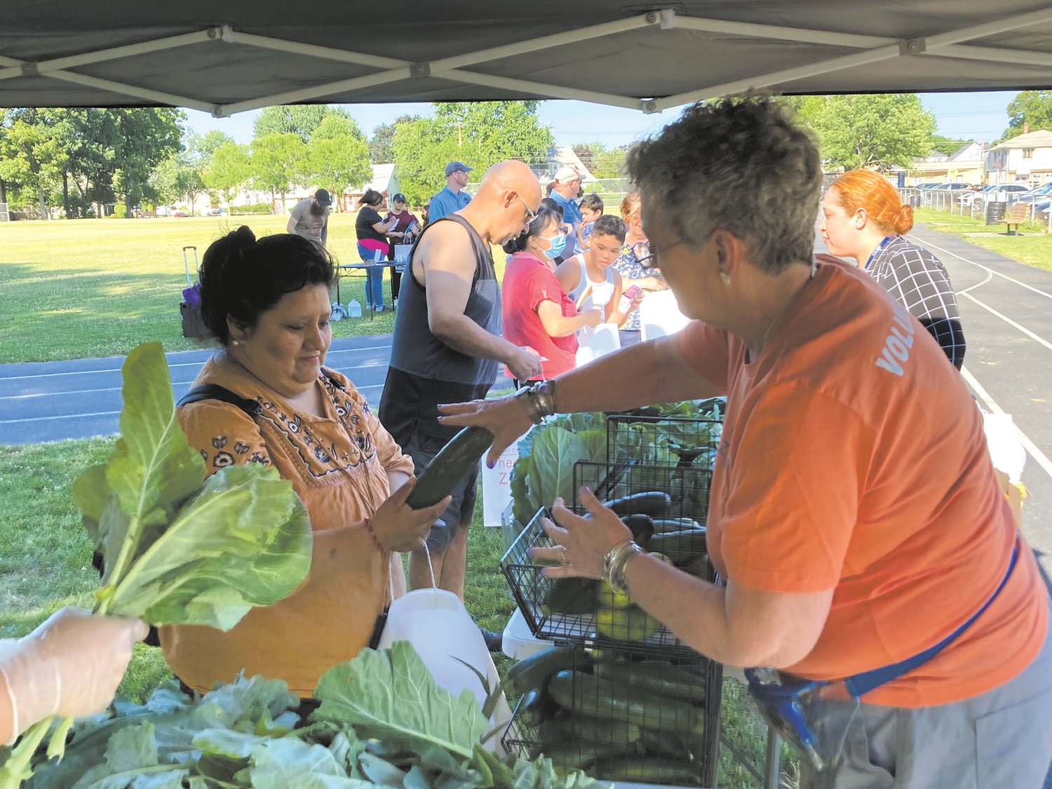 DISTRIBUTING TO FAMILIES: OneCranston HEZ purchases $1,000 of food each week to distribute to families. Last year, the organization gave away 1,300 bags of produce to Cranston residents. (Herald photo)